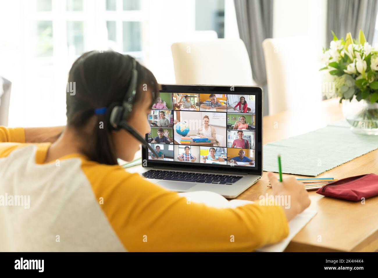 Asian girl using laptop for video call, with smiling diverse elementary ...