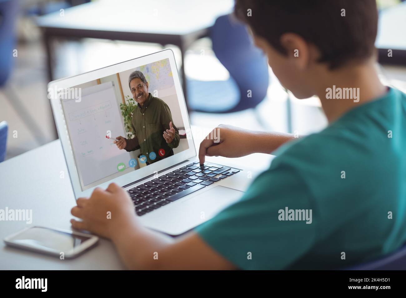 Male caucasian student having a video call with male teacher on laptop ...