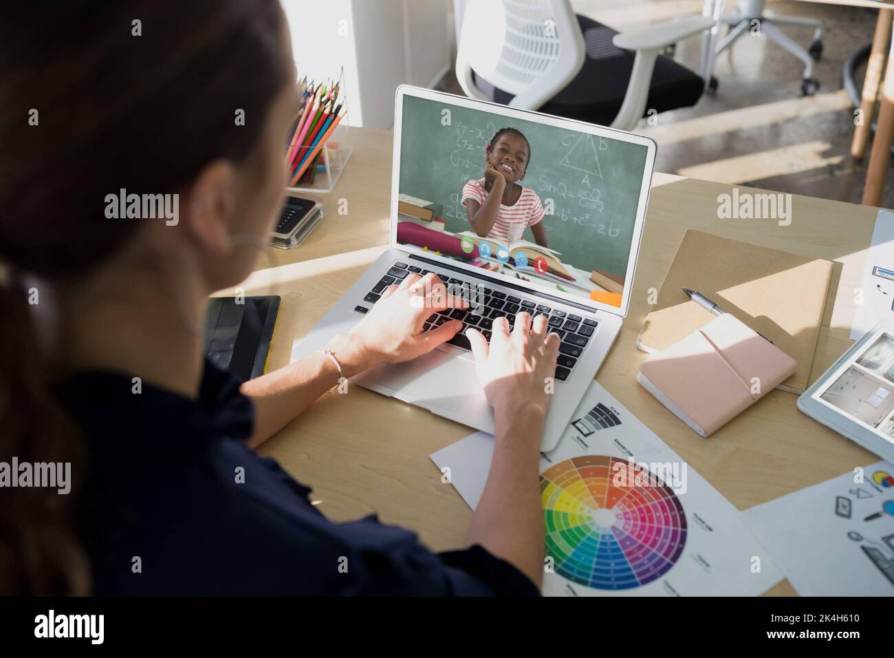 Female teacher having a video call with female student on laptop at ...