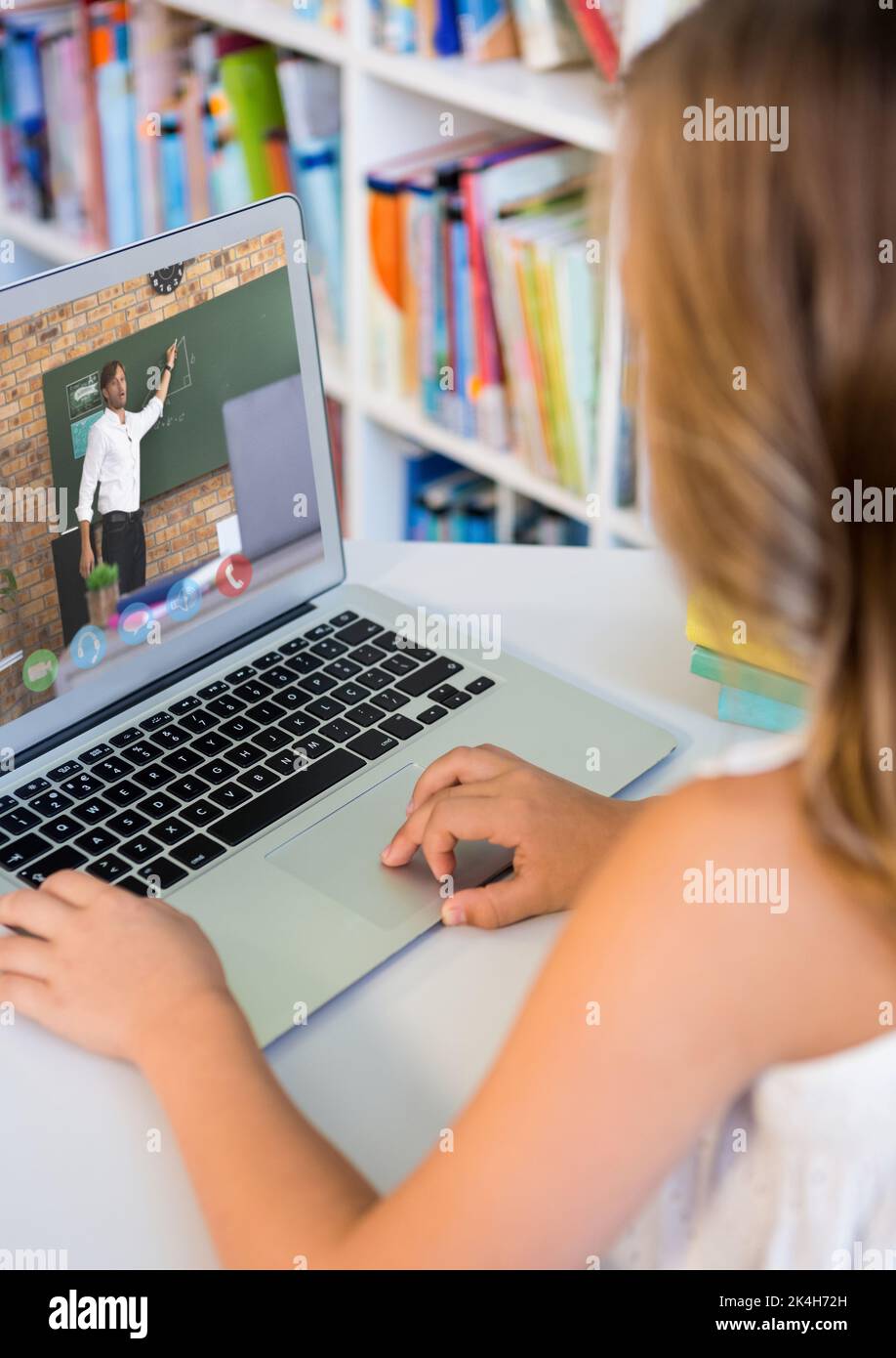 Female student having a video call with male teacher on laptop at ...