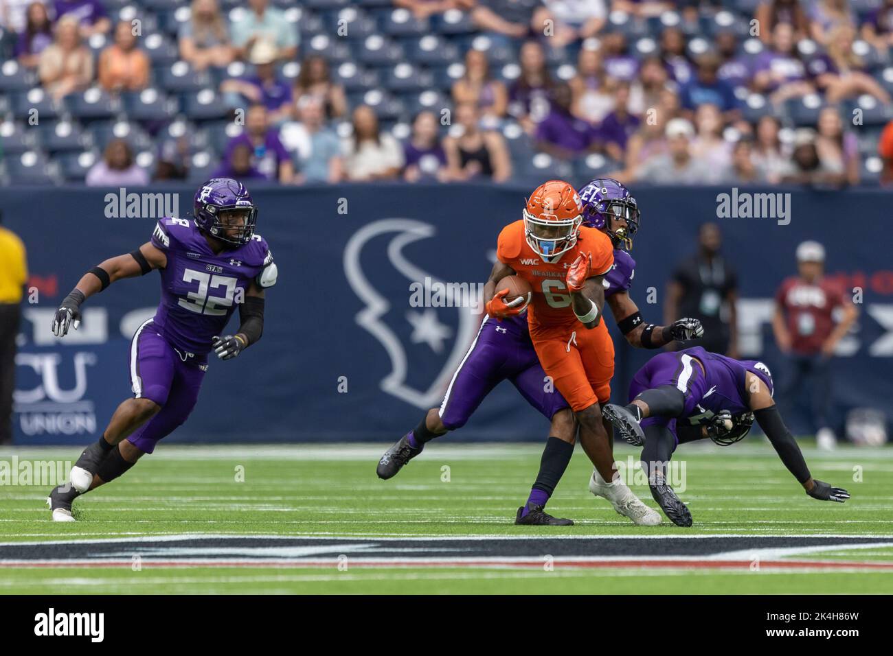 Sam Houston State Bearkats wide receiver Noah Smith (6) makes a catch as a trio of Stephen F. Austin Lumberjacks defenders close in for the tackle, Sa Stock Photo