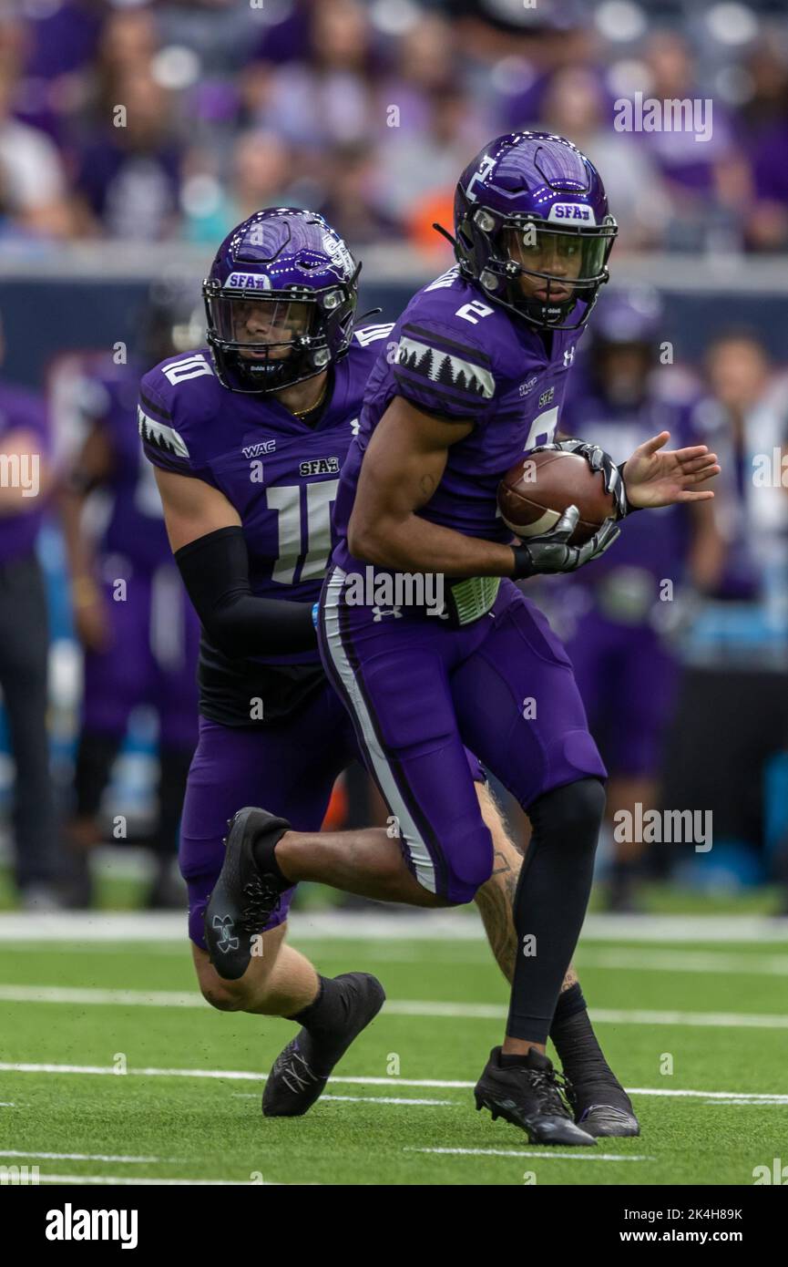 Stephen F. Austin Lumberjacks quarterback Brian Mauer (10) hands the ball off to wide receiver Xavier Gipson (2), Saturday, Oct. 1, 2022, in Houston, Stock Photo