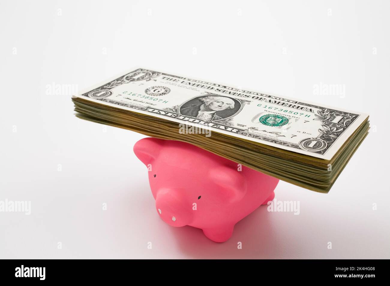 US currency bank notes on top of pink piggy bank Stock Photo Alamy