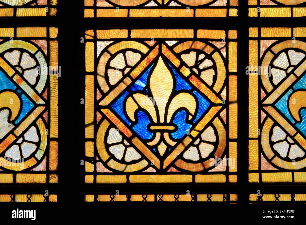 A fleur-de-lys stained glass window (symbol of the kings of France) at the basilica of Bois-Chenu in Domrémy-la-Pucelle (Vosges), France Stock Photo