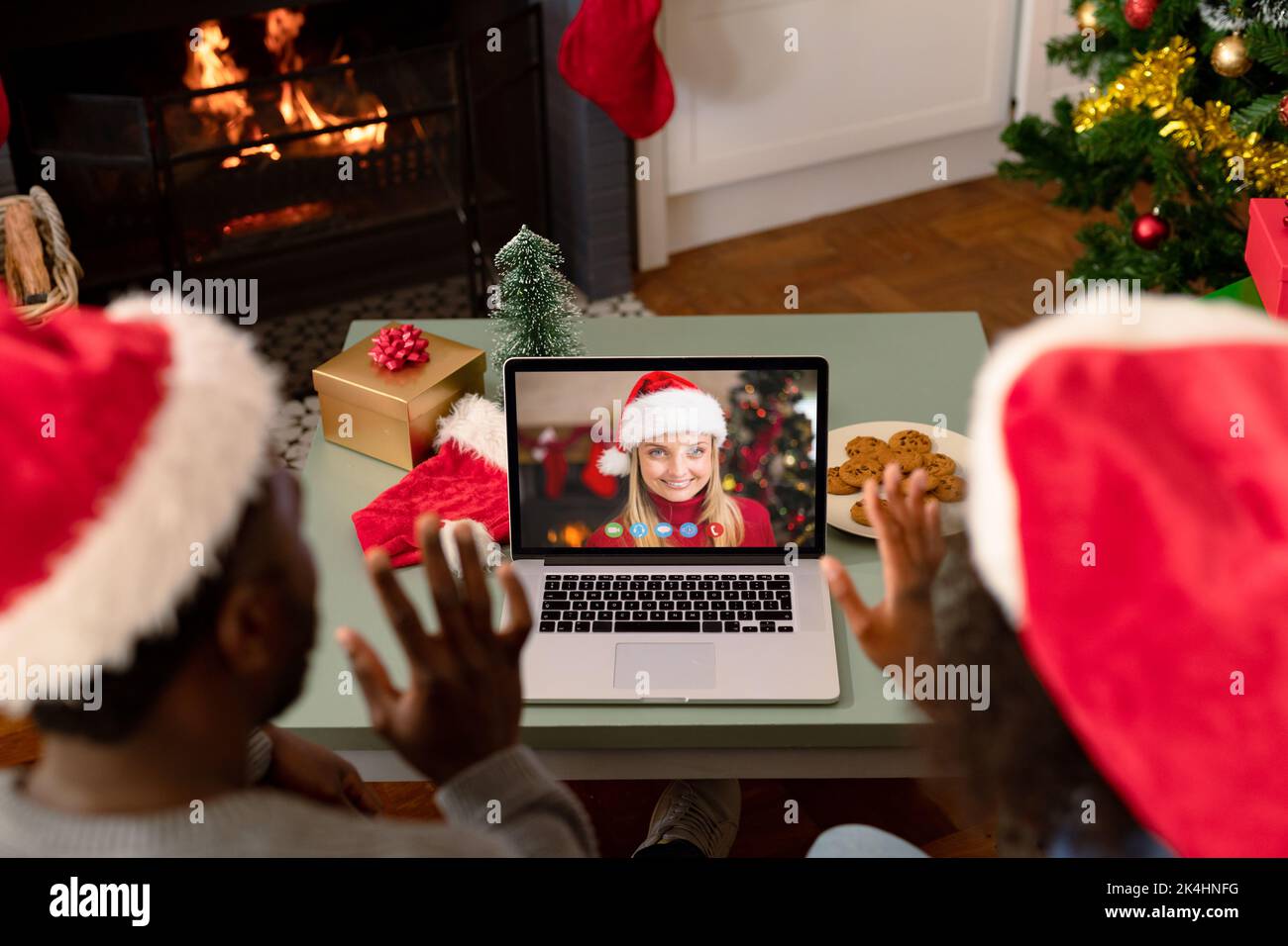 African american couple in santa hats on christmas video call with ...