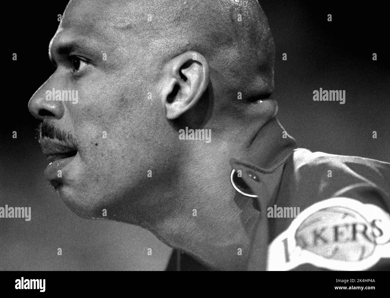 NBA superstar Kareem Abdul-Jabbar of the Los Angeles Lakers is shown in profile on the bench during a game in 1988. Stock Photo