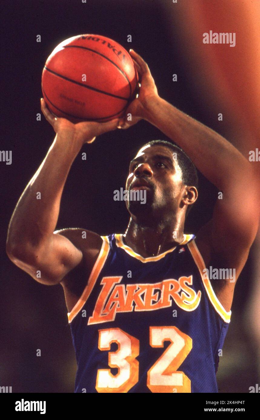 NBA superstar Ervin 'Magic' Johnson shoots a free throw during game action vs the Chicago Bulls in the 1980s. Stock Photo