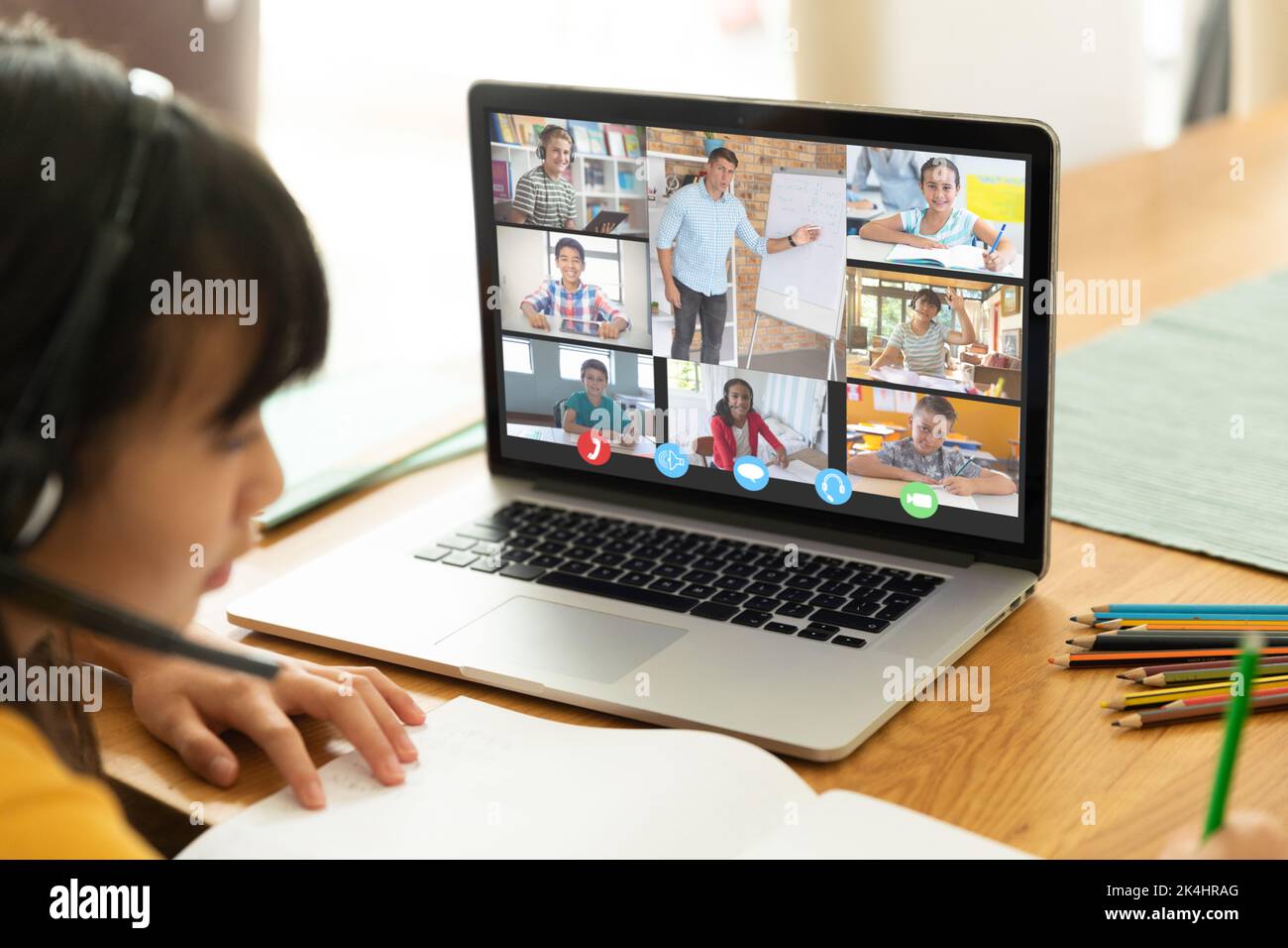 Asian girl using laptop for video call, with smiling diverse elementary ...