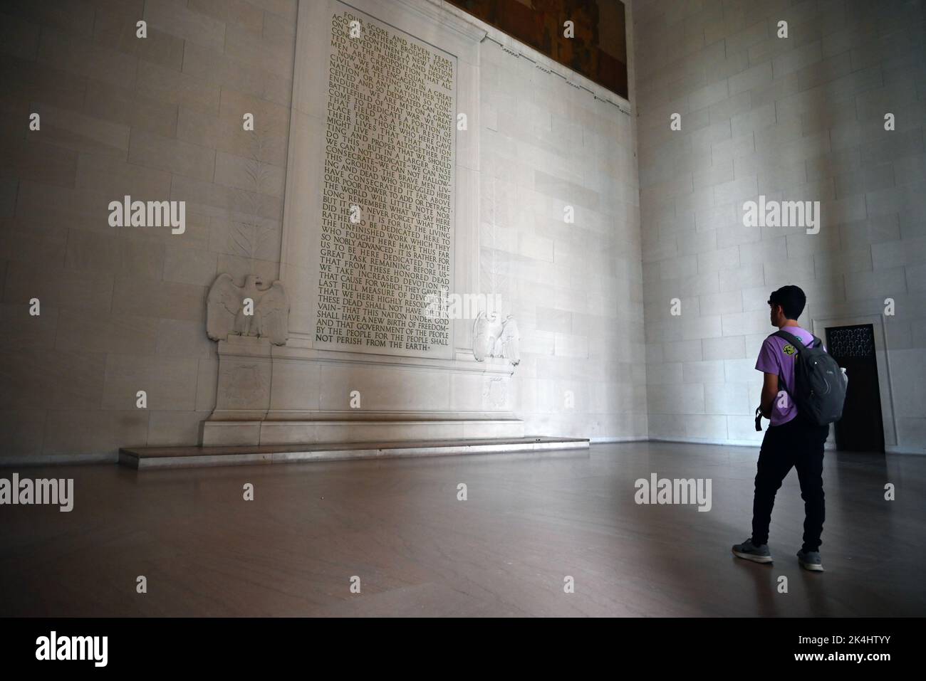 A young man reads Abraham Lincoln's Gettysburg Address memorialized on the wall at the Lincoln Memorial in Washington, DC. Stock Photo