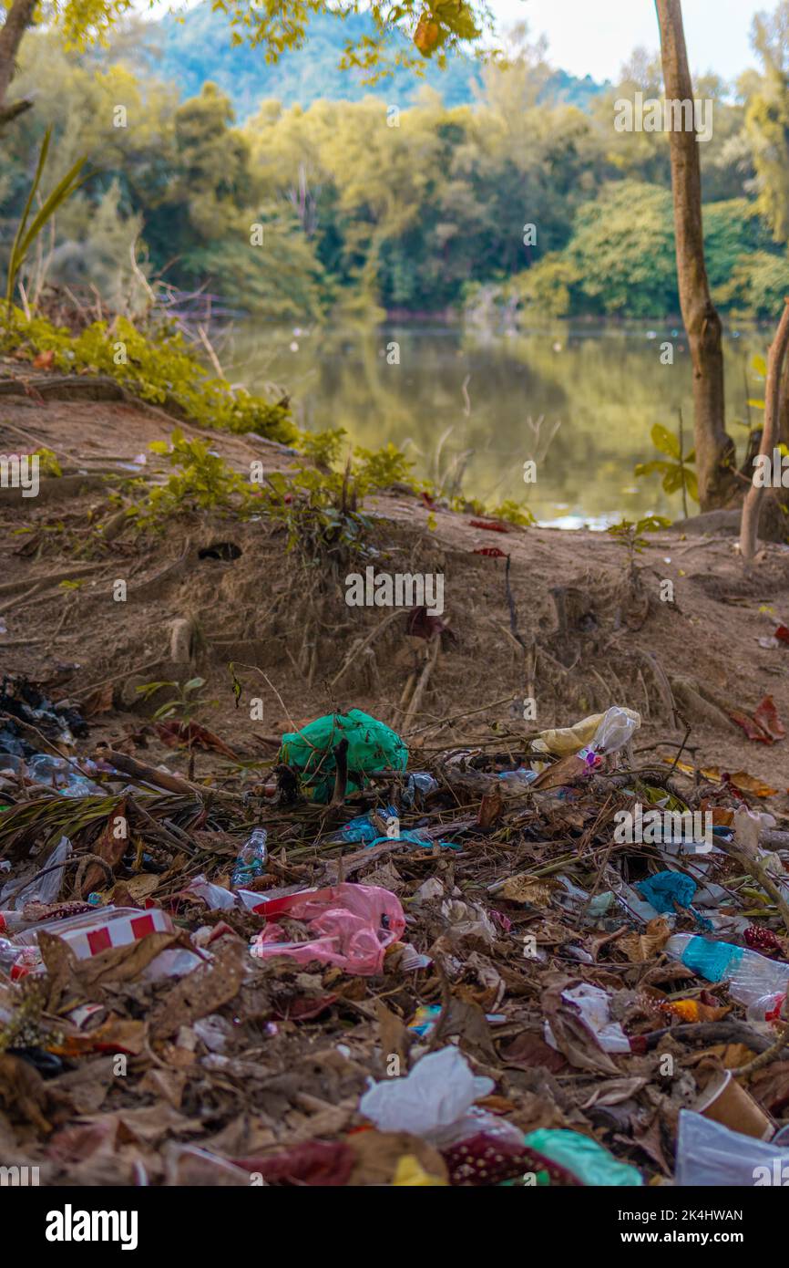 Garbage waste disposal by the lakeside. Environmental Pollution. Global Warming. Save Earth Stock Photo