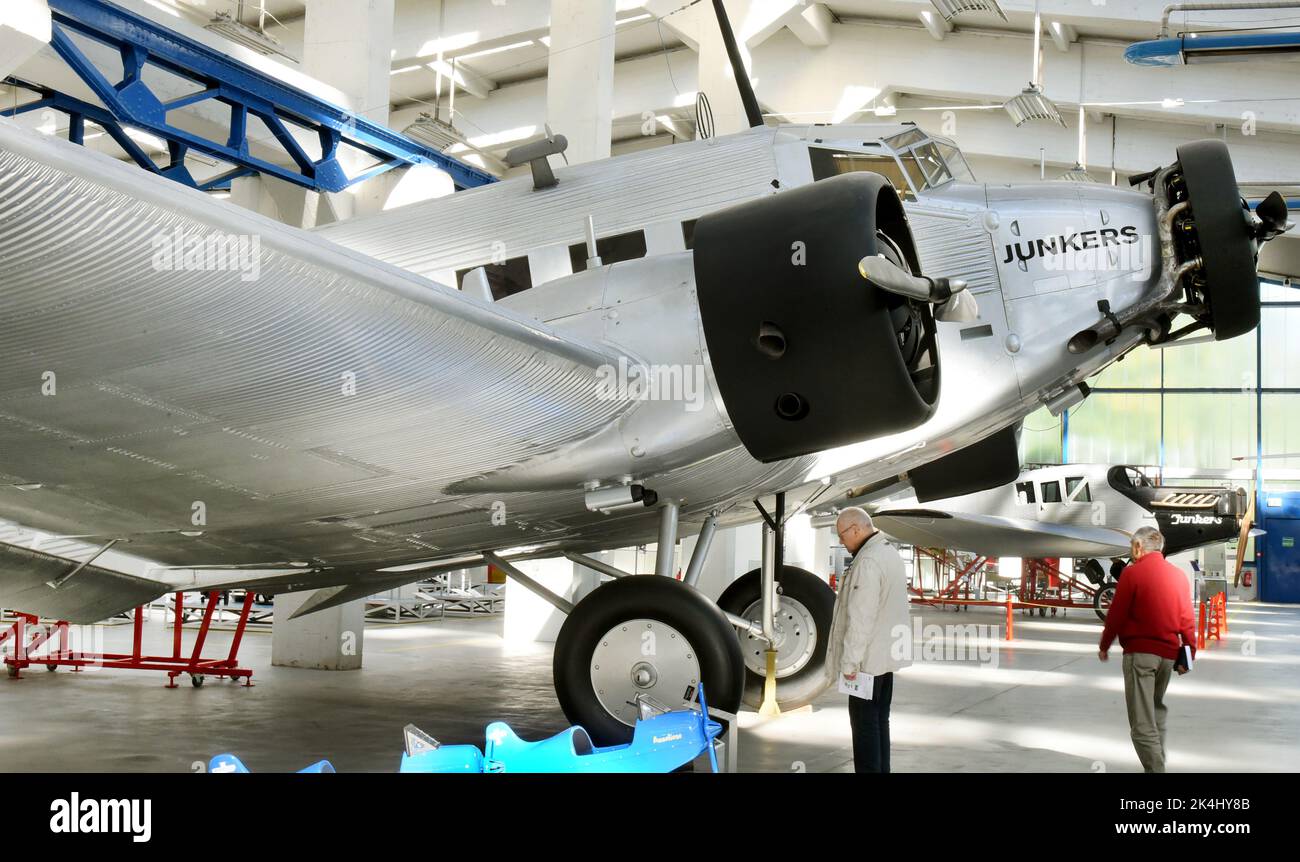 29 September 2022, Saxony-Anhalt, Dessau-Roßlau: In the 'Hugo Junkers' Museum of Technology, visitors view a restored Junkers Ju 52/3m. The aircraft, also known as 'Aunt Ju,' is the special exhibit in the museum. It sank during World War II after an emergency landing on the ice in Lake Hartvik near Narvik and was raised relatively intact in 1986. In 1995, she returned to Dessau and was restored by members of the Förderverein Technikmuseum Hugo Junkers. The museum in Dessau-Roßlau is dedicated to the aircraft designer and entrepreneur Hugo Junkers (Hugo Junkers born February 3, 1859 - died Febr Stock Photo