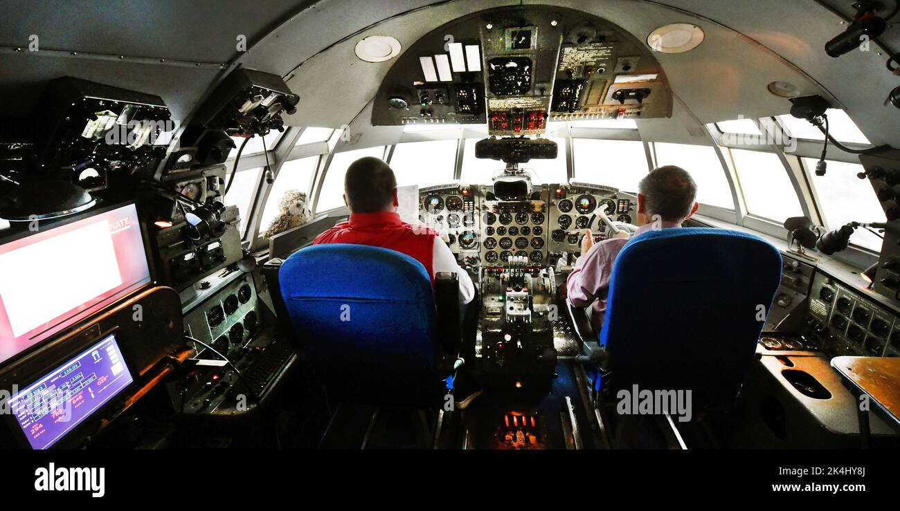 29 September 2022, Saxony-Anhalt, Dessau-Roßlau: In the 'Hugo Junkers' Museum of Technology, information electronics technician Henry Bergmann (l) adjusts systems in an IL18 flight simulator with former commercial pilot and managing director Gerd Fucke. The simulator, which was used by Interflug pilots in Moscow to practice emergency situations until the 1980s, is one of the exhibits dedicated to the aircraft designer and entrepreneur Hugo Junkers (Hugo Junkers born February 3, 1859 - died February 3, 1935). The museum, which opened in 2001 on the site of the former Junkers aircraft factory, i Stock Photo