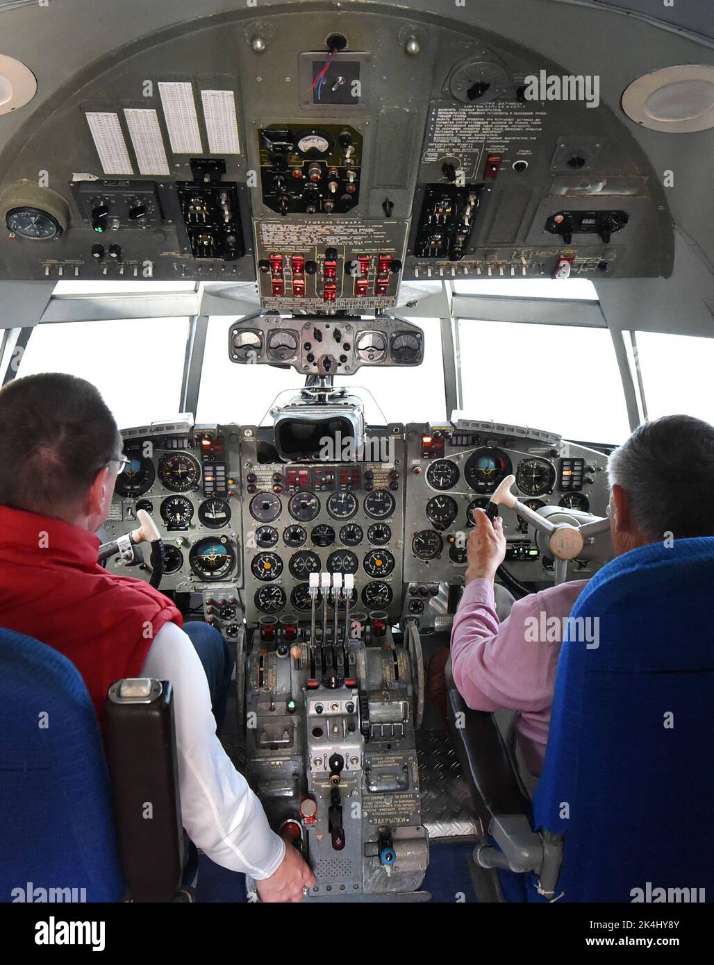 29 September 2022, Saxony-Anhalt, Dessau-Roßlau: In the 'Hugo Junkers' Museum of Technology, information electronics technician Henry Bergmann (l) adjusts systems in an IL18 flight simulator with former commercial pilot and managing director Gerd Fucke. The simulator, which was used by Interflug pilots in Moscow to practice emergency situations until the 1980s, is one of the exhibits dedicated to the aircraft designer and entrepreneur Hugo Junkers (Hugo Junkers born February 3, 1859 - died February 3, 1935). The museum, which opened in 2001 on the site of the former Junkers aircraft factory, i Stock Photo