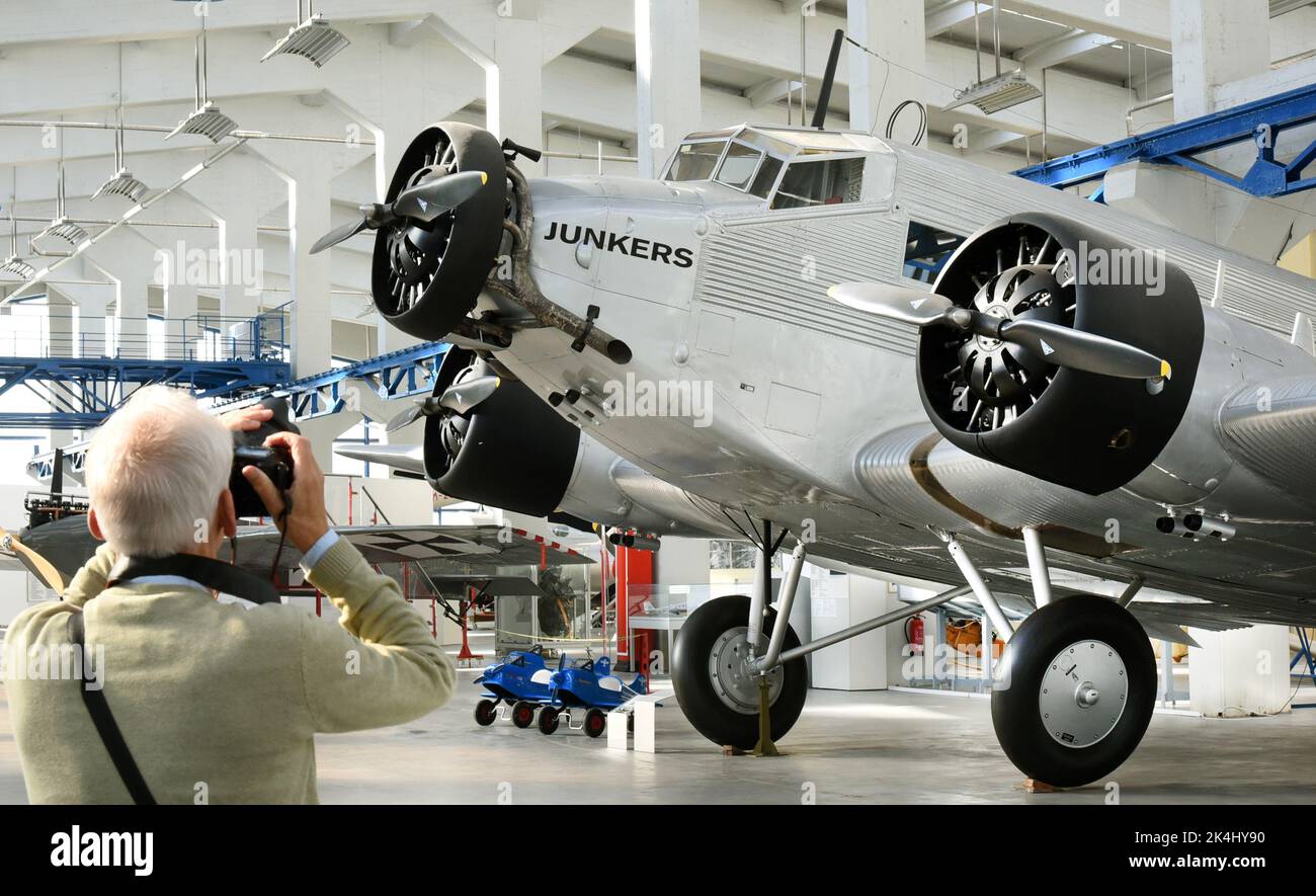 29 September 2022, Saxony-Anhalt, Dessau-Roßlau: A visitor takes a photo of a restored Junkers Ju 52/3m at the 'Hugo Junkers' Museum of Technology. The aircraft, also known as 'Aunt Ju,' is the special exhibit in the museum. It sank during World War II after an emergency landing on the ice in Lake Hartvik near Narvik and was raised relatively intact in 1986. In 1995, she returned to Dessau and was restored by members of the Förderverein Technikmuseum Hugo Junkers. The museum in Dessau-Roßlau is dedicated to the aircraft designer and entrepreneur Hugo Junkers (Hugo Junkers born February 3, 1859 Stock Photo