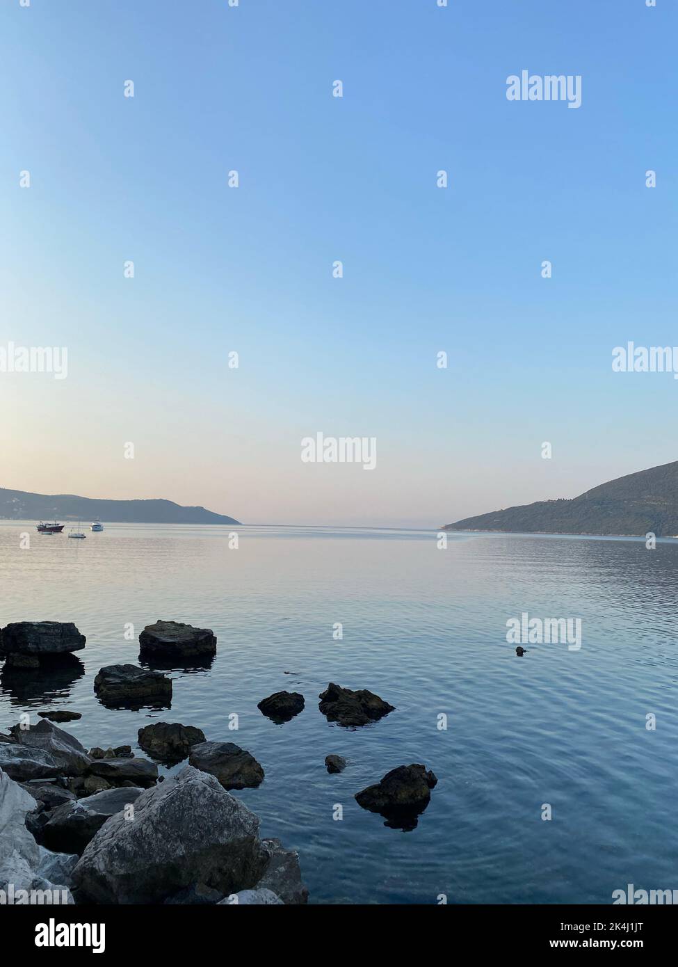 A beautiful view of rocks and the sea at sunset Stock Photo - Alamy