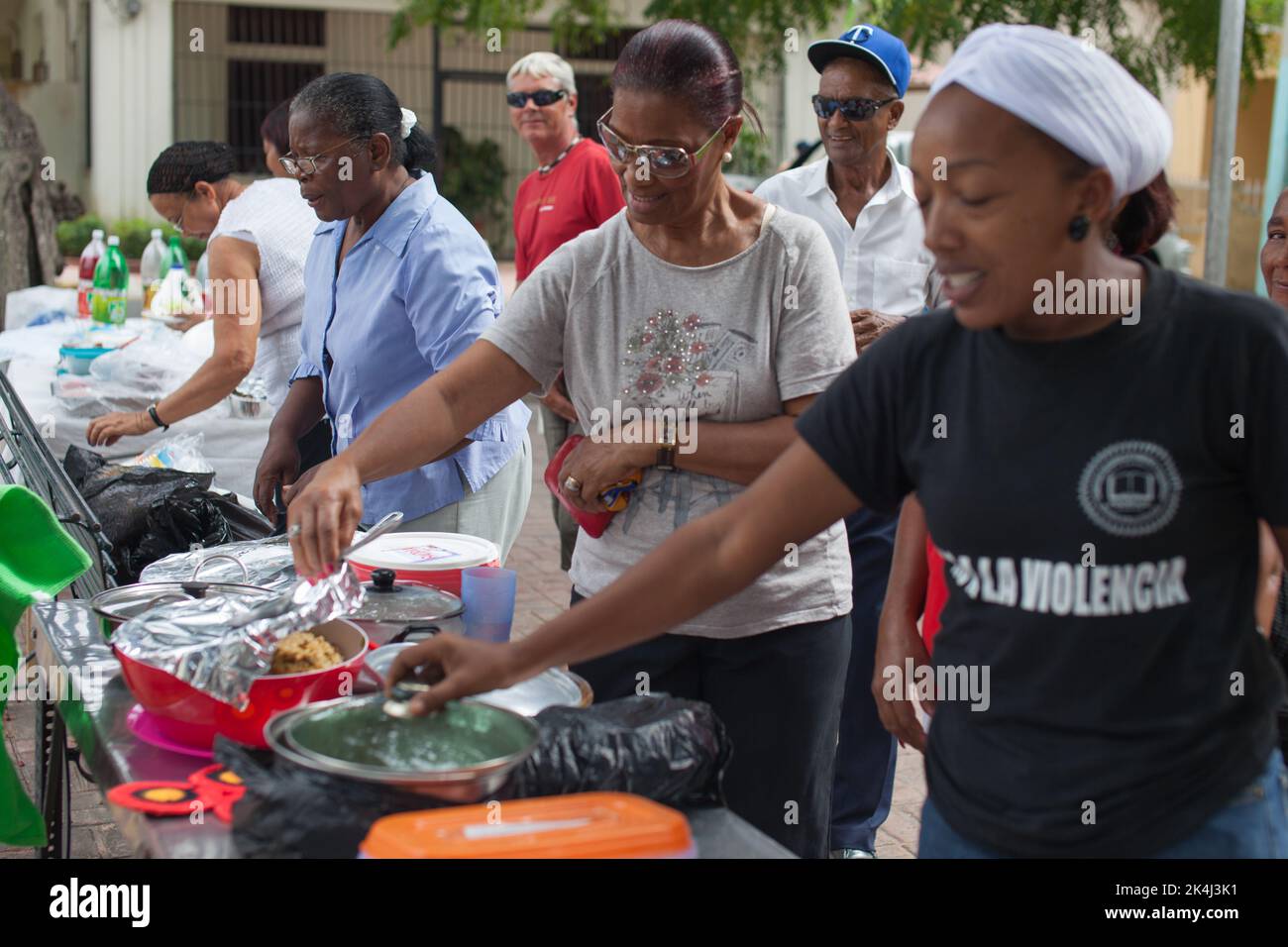 Boca Chica, Santo Domingo, November 25, 2012: Volunteers feeding the hungry in Boca Chica. Stock Photo