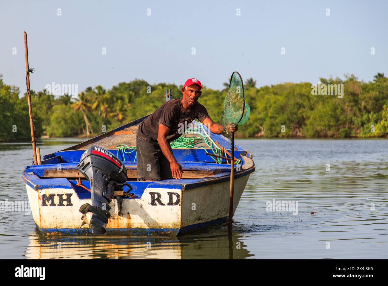 Miches, El Seibo, May 23, 2015: Fisherman on his way out to sea to fish in Miches, Dominican Republic. Stock Photo