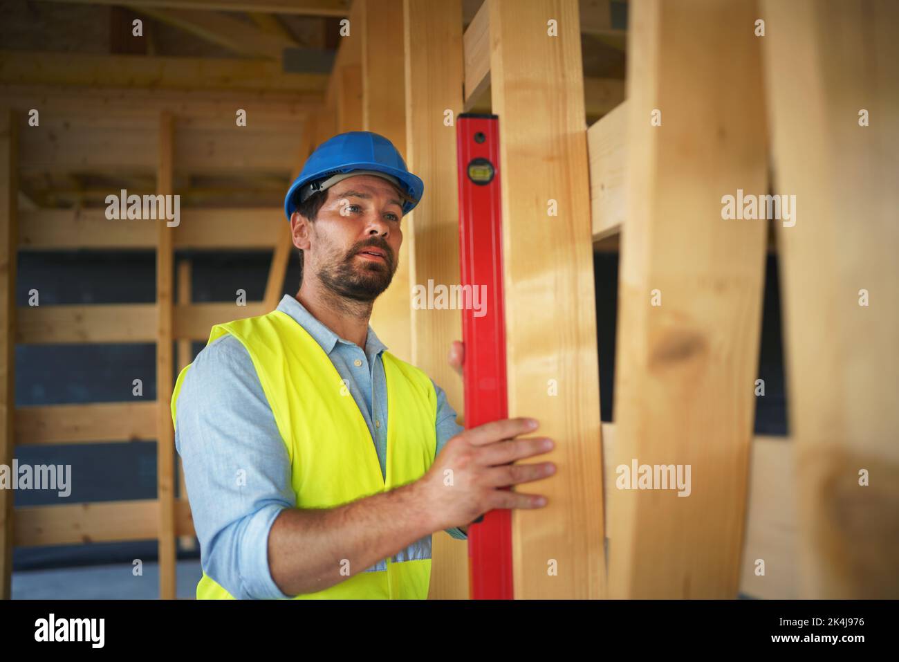 Carpenter checking wooden planks with spirit level, diy eco-friendly ...