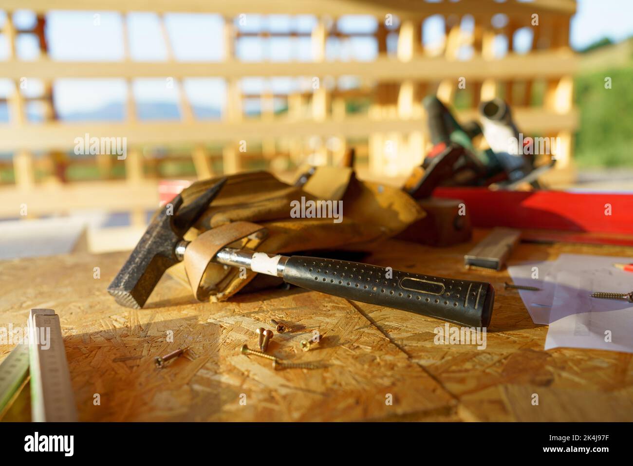 Close up of construction tools inside of unfinished wooden house. Stock Photo