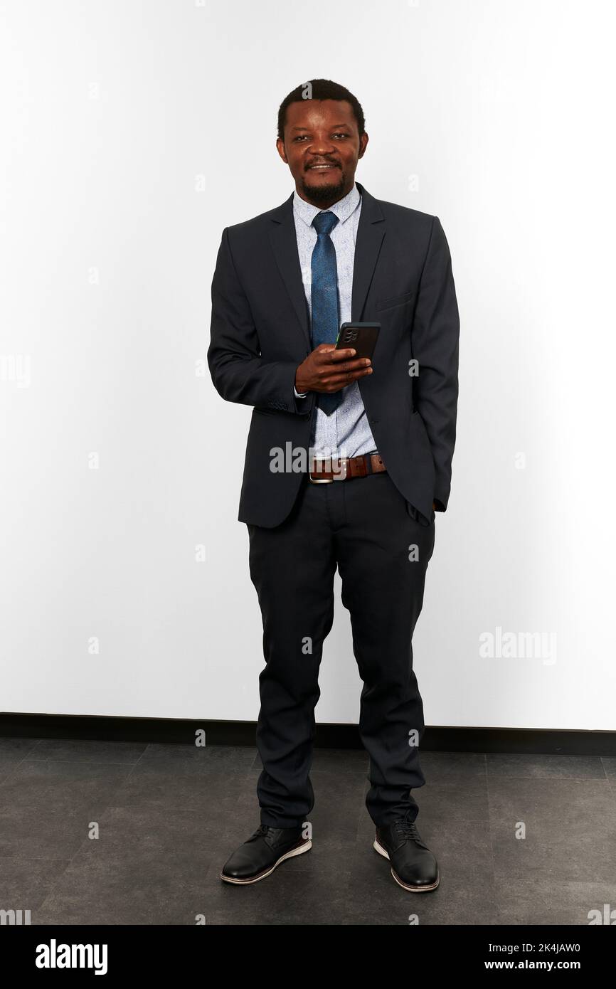 Smiling african american black man in business suit with smartphone in ...