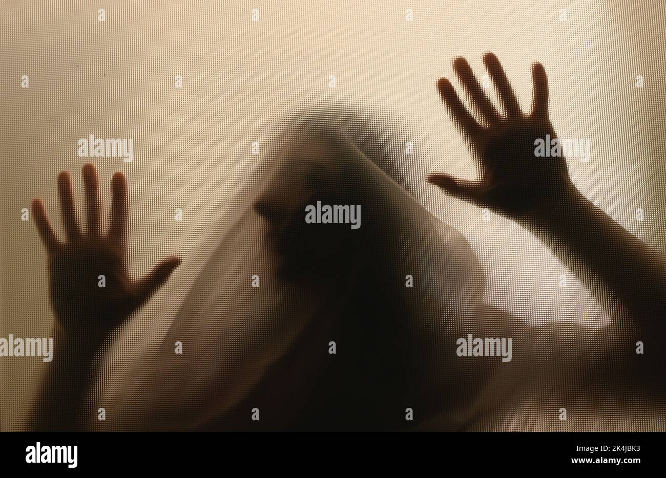 Horror ghost woman behind the matte glass. Halloween festival concept. Stock Photo