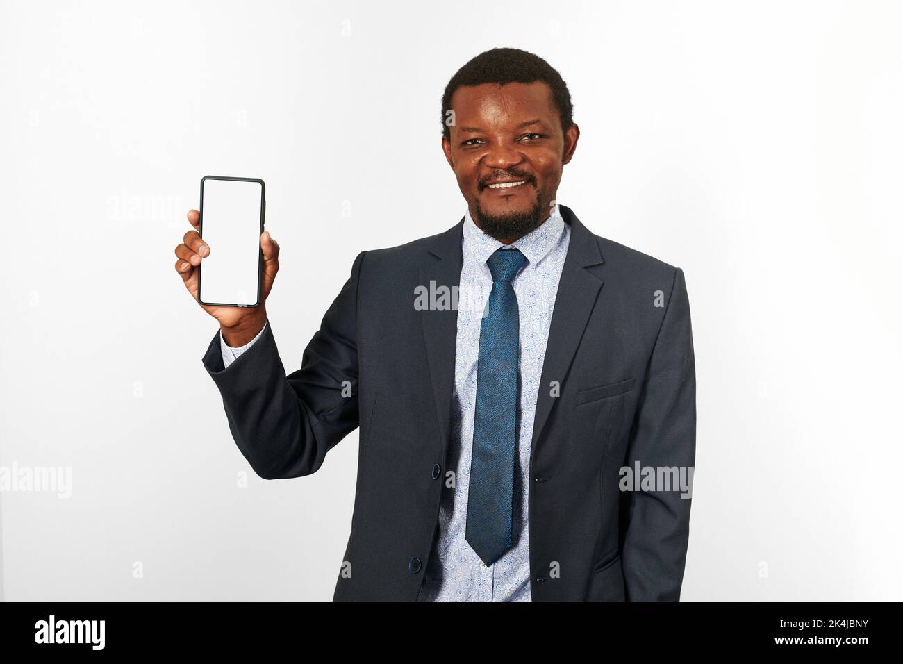Smiling african american black man in business suit with smartphone ...