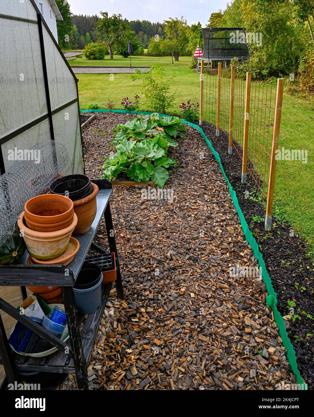 greenhouse and gardening table in cultivating area Stock Photo