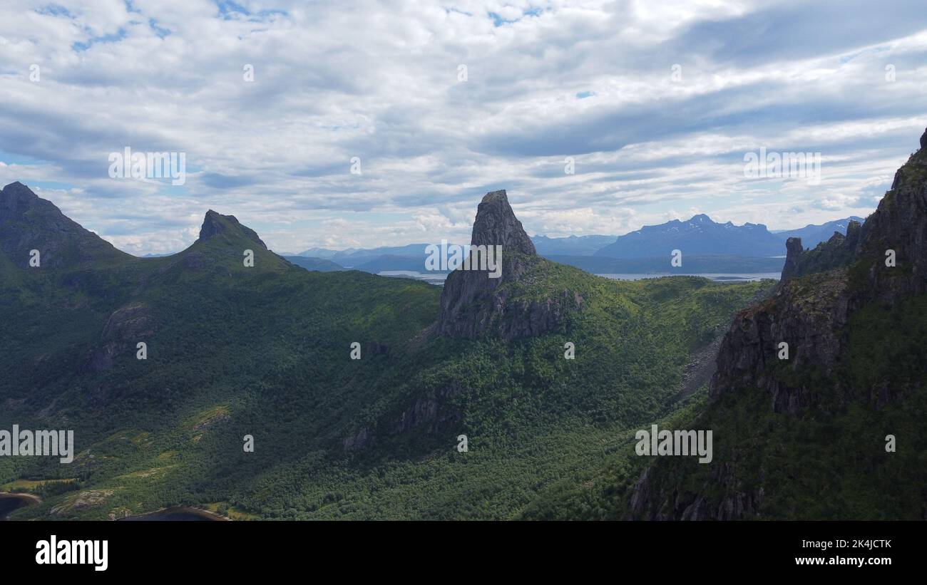 An aerial view of green hills at the shore on a bright sunny day with ...