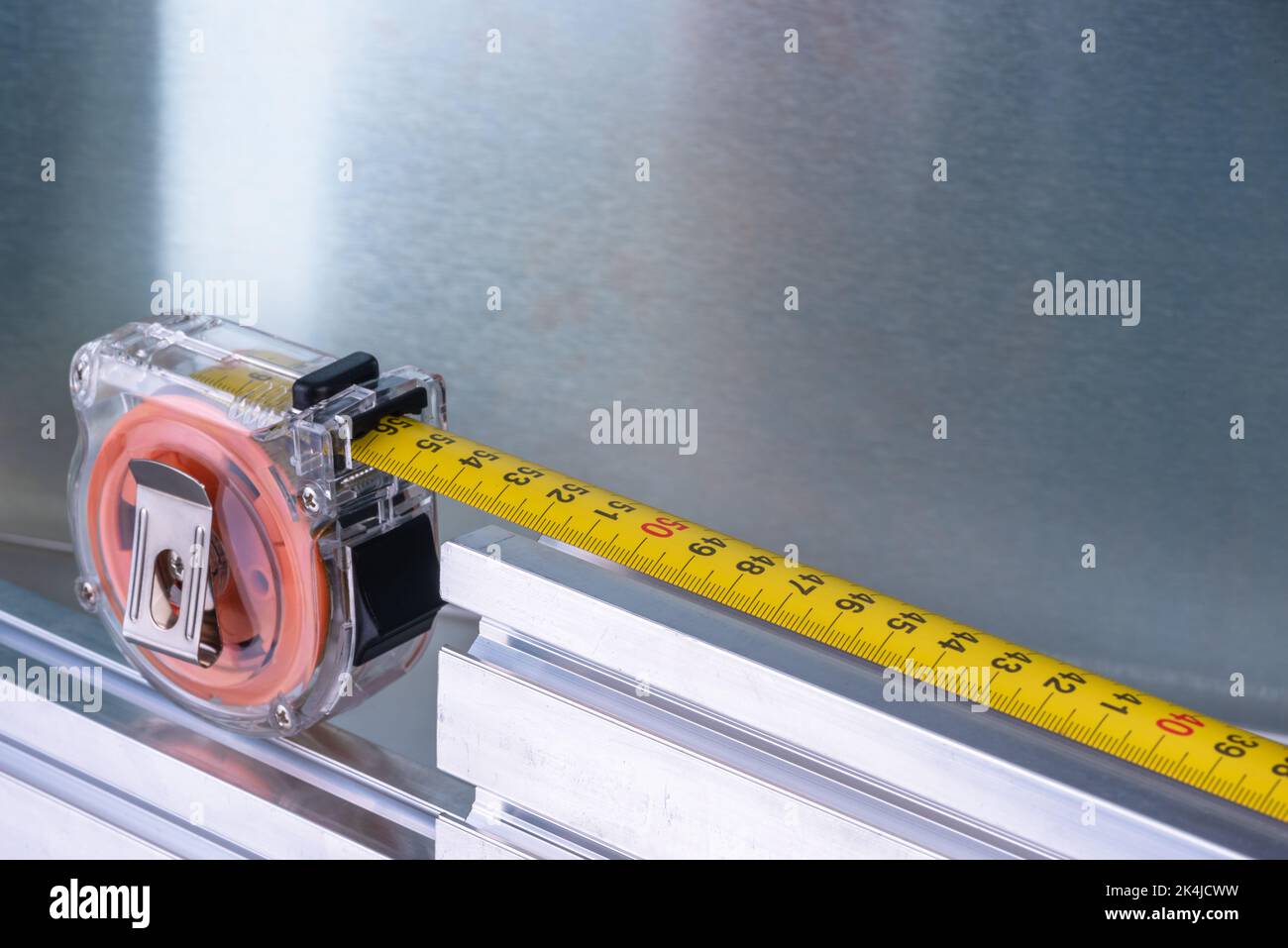Measuring tape with metal profiles, tool and component of construction industry Stock Photo
