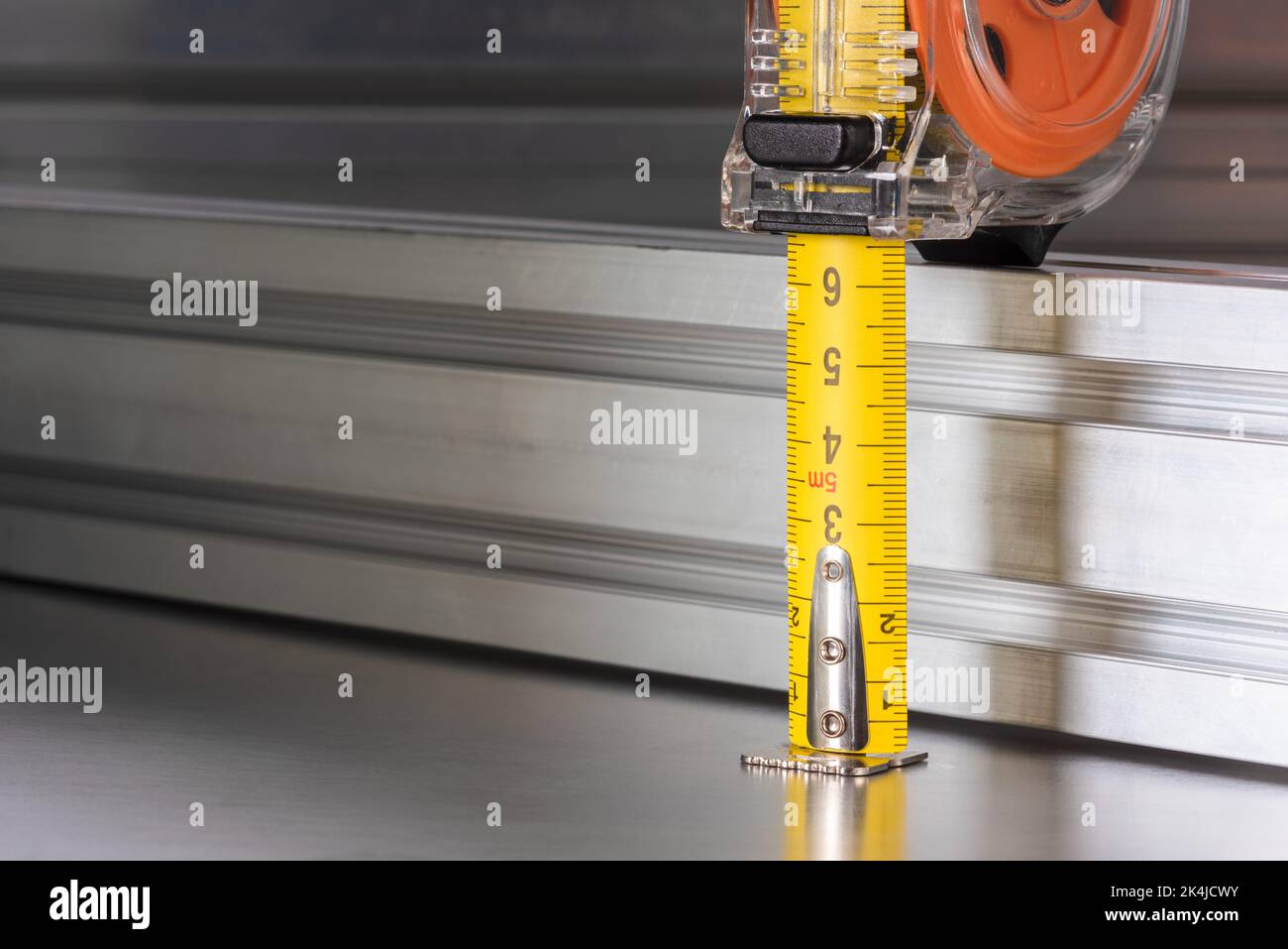 Measuring tape with metal profiles, tool and component of construction industry Stock Photo