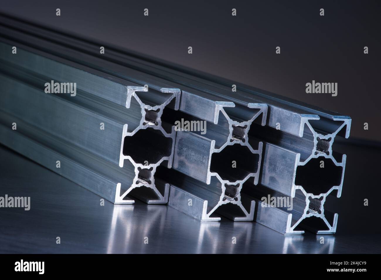 Aluminum exstrusion profile on gray background, component of metalurgy industry Stock Photo