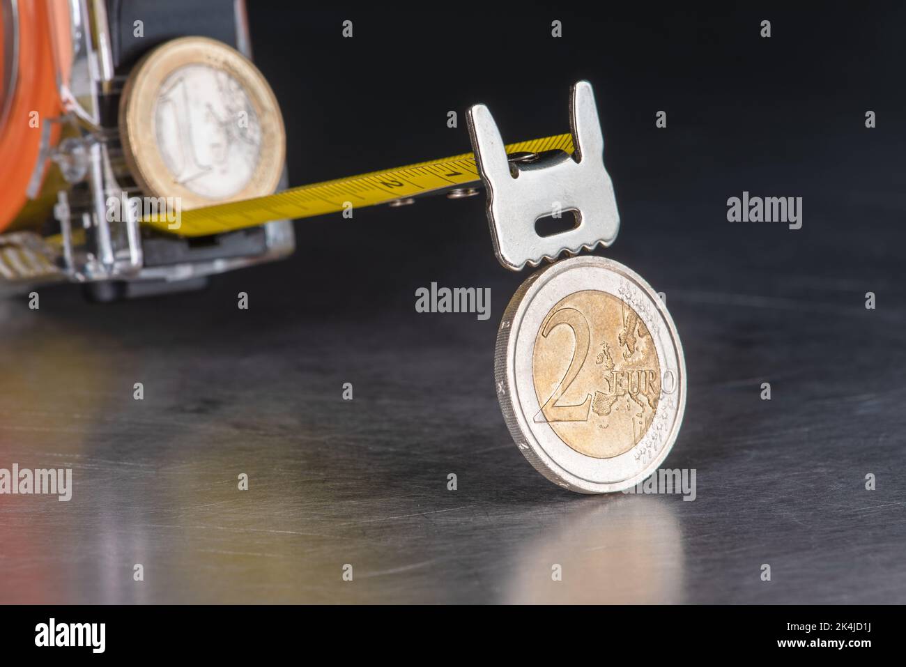 Inflation concept, coins and measure tape as rising prices Stock Photo