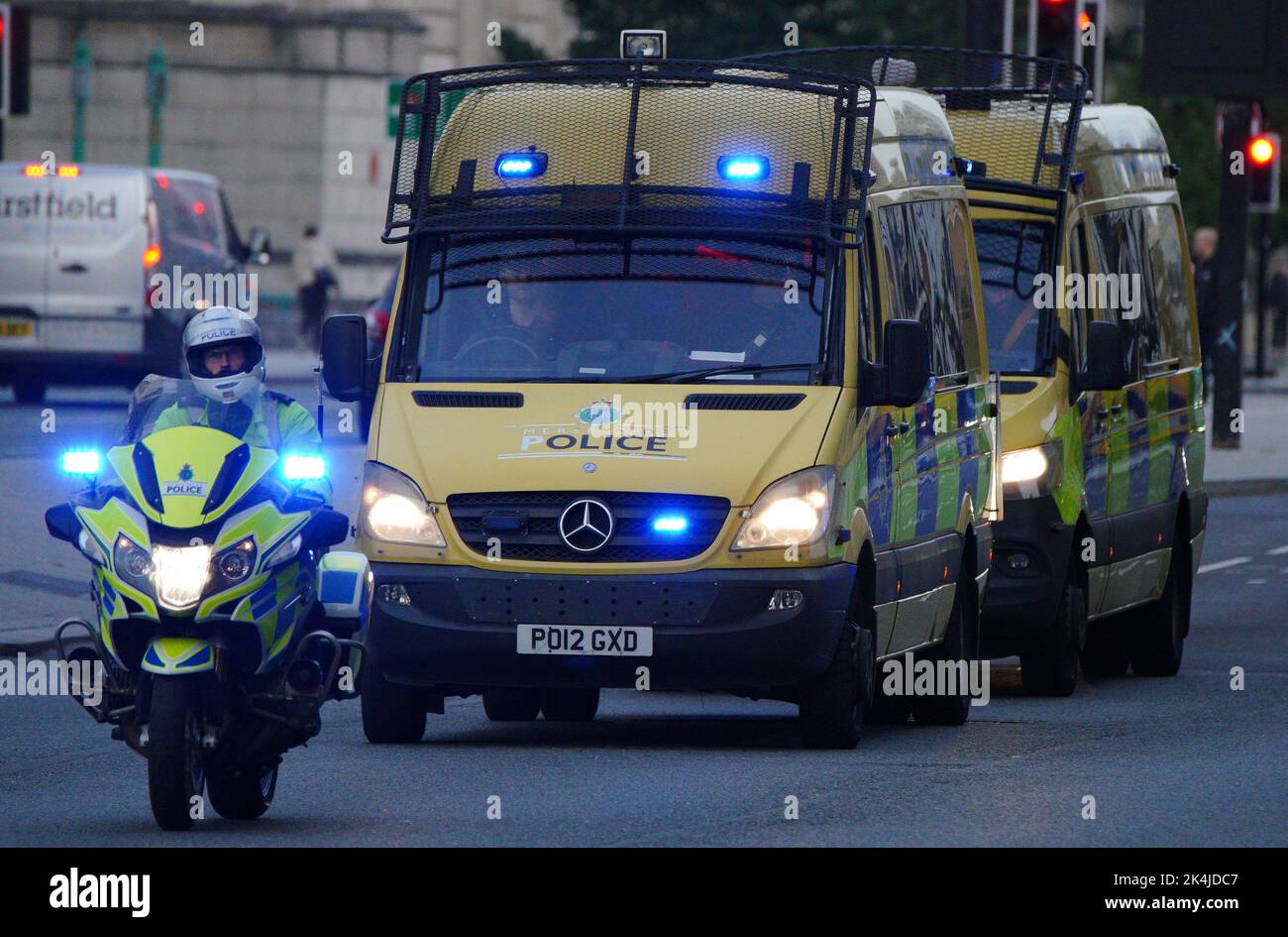 Police motorcycles block the road to other traffic as a vehicle carrying Thomas Cashman arrives