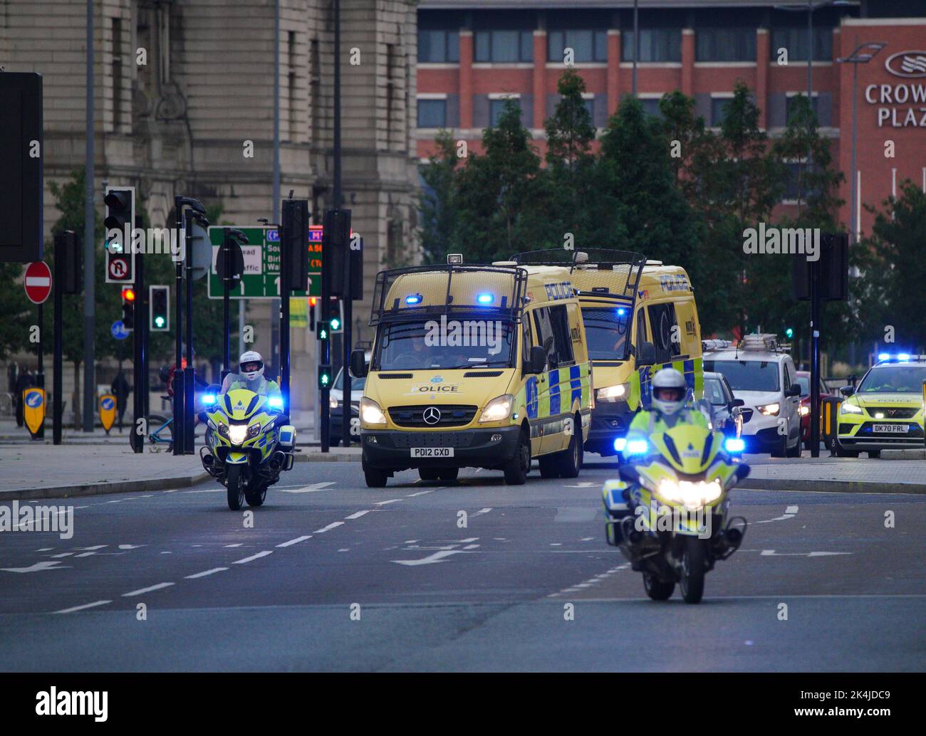 Police motorcycles block the road to other traffic as a vehicle carrying Thomas Cashman arrives