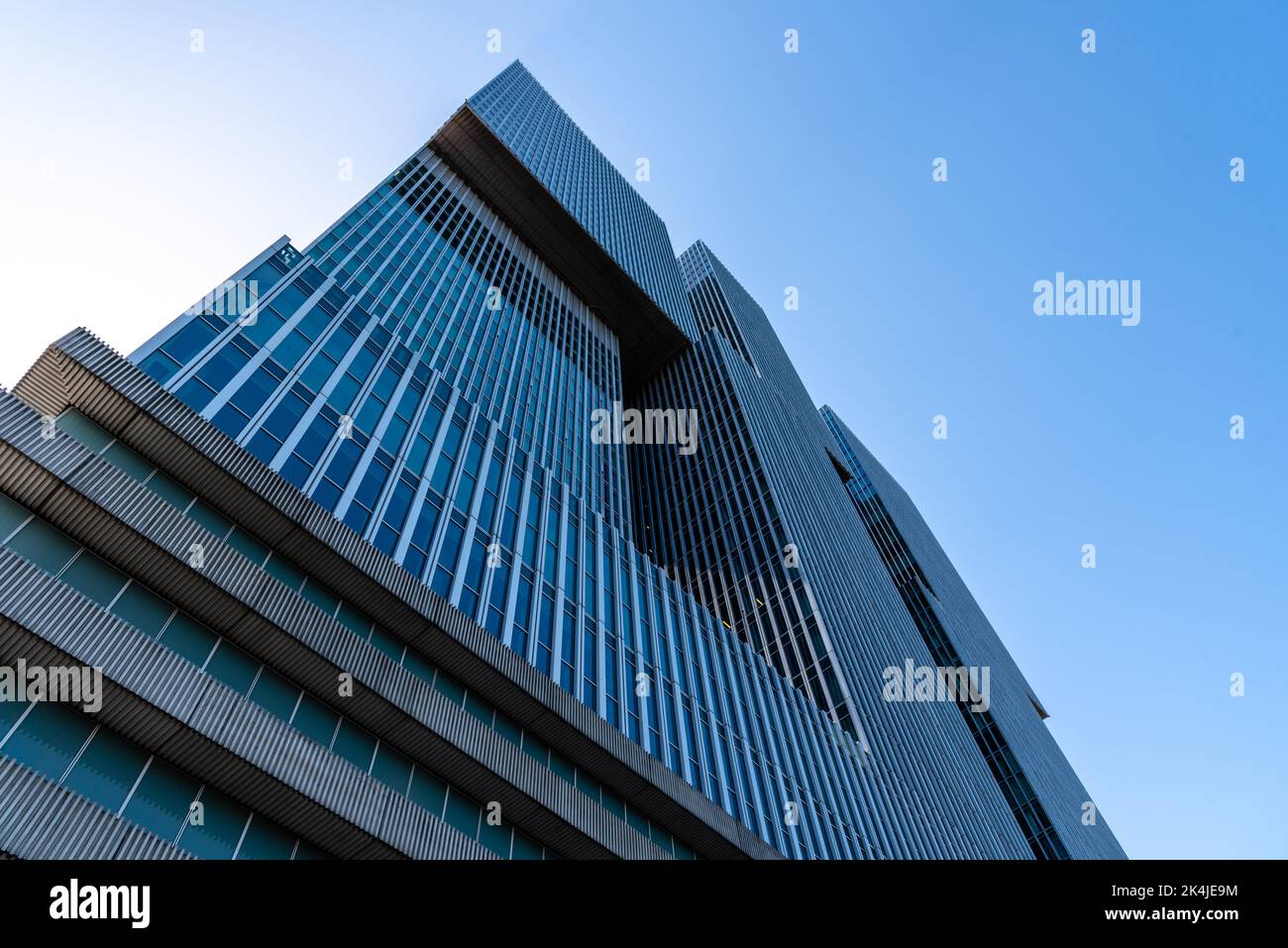 Rotterdam, Netherlands - May 8, 2022: De Rotterdam Skyscraper against sky. Designed by Rem Koolhaas architect. Contemporary architecture. Low angle vi Stock Photo