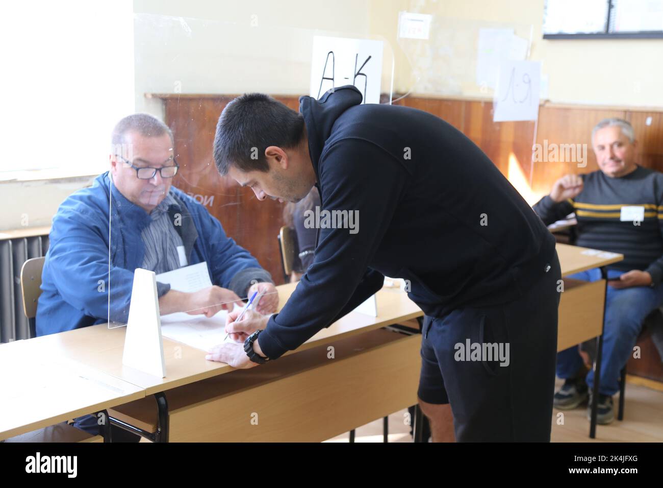 Sofia, Bulgaria. 2nd Oct, 2022. A man prepares to vote during the early parliamentary elections at a polling station in Sofia, Bulgaria, Oct. 2, 2022. TO GO WITH 'GERB-UDF coalition leads in Bulgaria's parliamentary elections: exit polls' Credit: Lin Hao/Xinhua/Alamy Live News Stock Photo