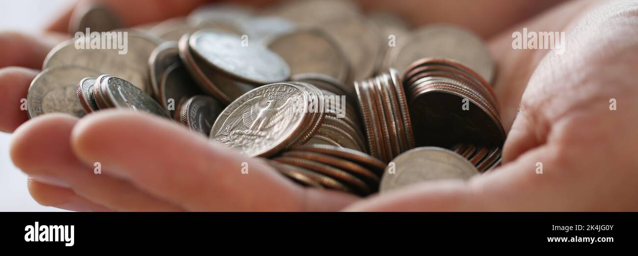 Pile of coins in businessman hands, earned money, work hard Stock Photo ...
