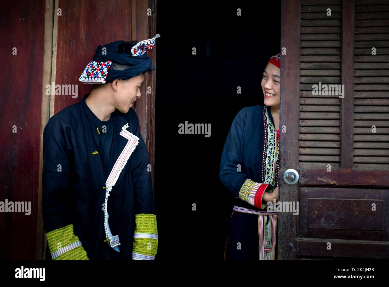 Sa Pa Town, Lao Cai Province, Vietnam - September 2, 2022: Portrait of a young man and girl in traditional costumes of the Red Dao ethnic minority in Stock Photo