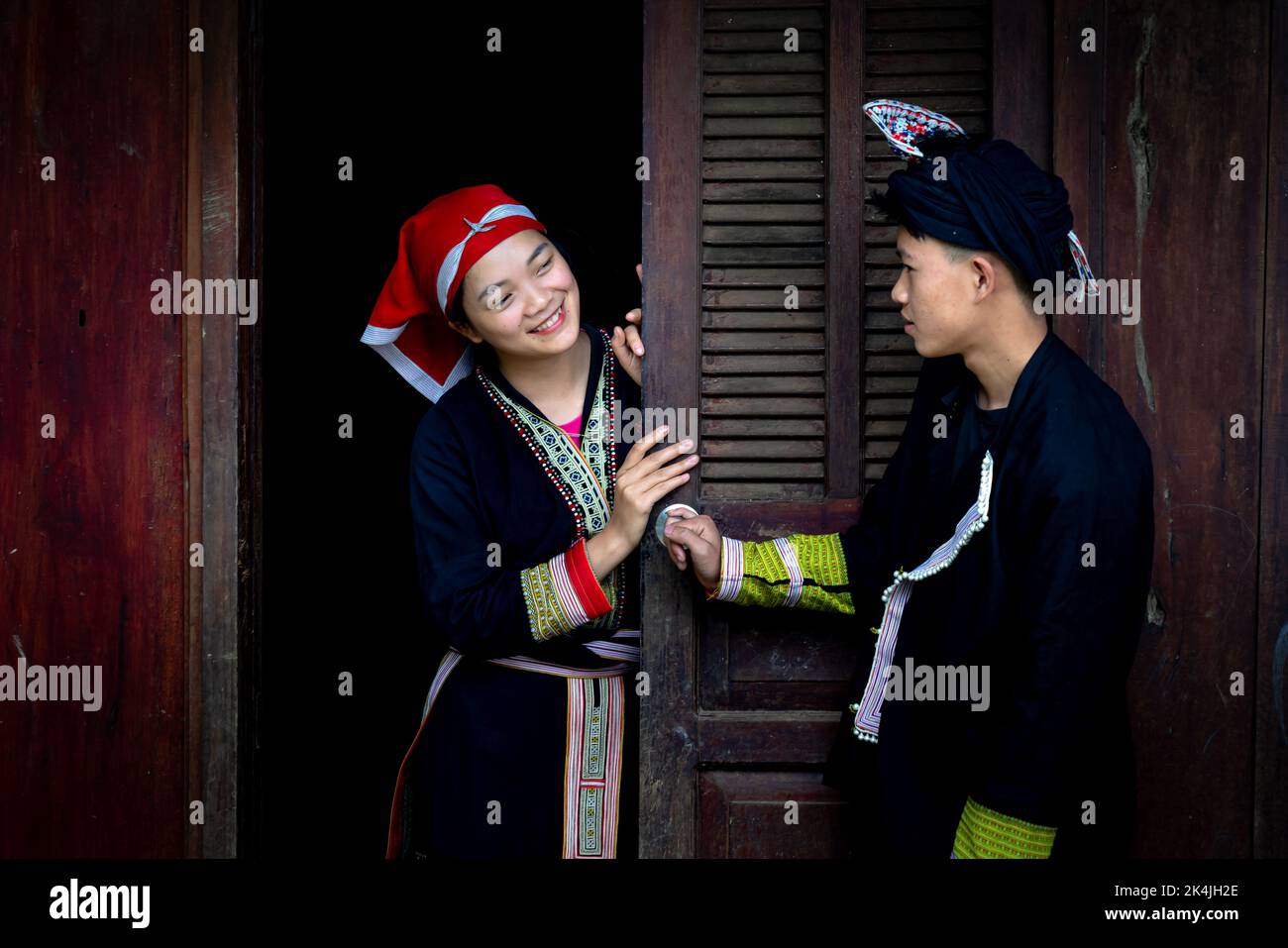 Sa Pa Town, Lao Cai Province, Vietnam - September 2, 2022: Portrait of a young man and girl in traditional costumes of the Red Dao ethnic minority in Stock Photo