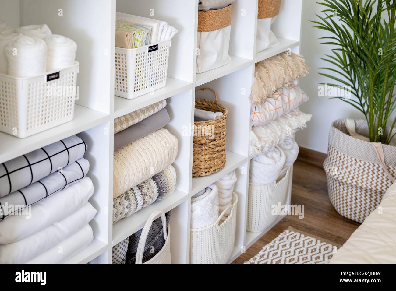 Neatly folded linen cupboard shelves storage at eco friendly straw