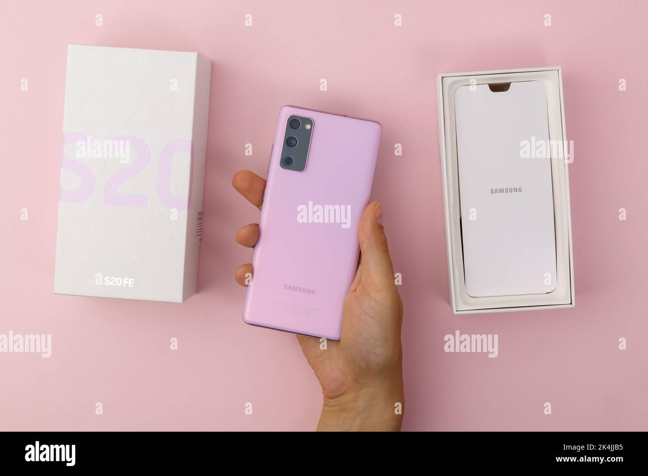Tyumen, Russia-July 18, 2022: New Samsung s20 fe smartphone in a box. Top view, pink background Stock Photo