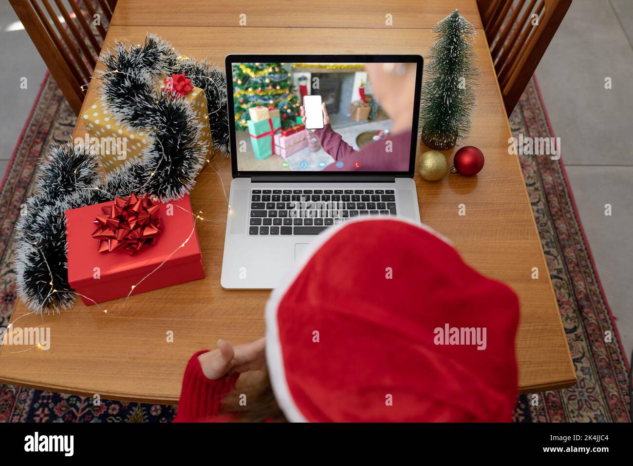 Caucasian woman in santa hat on laptop christmas video call with friend ...