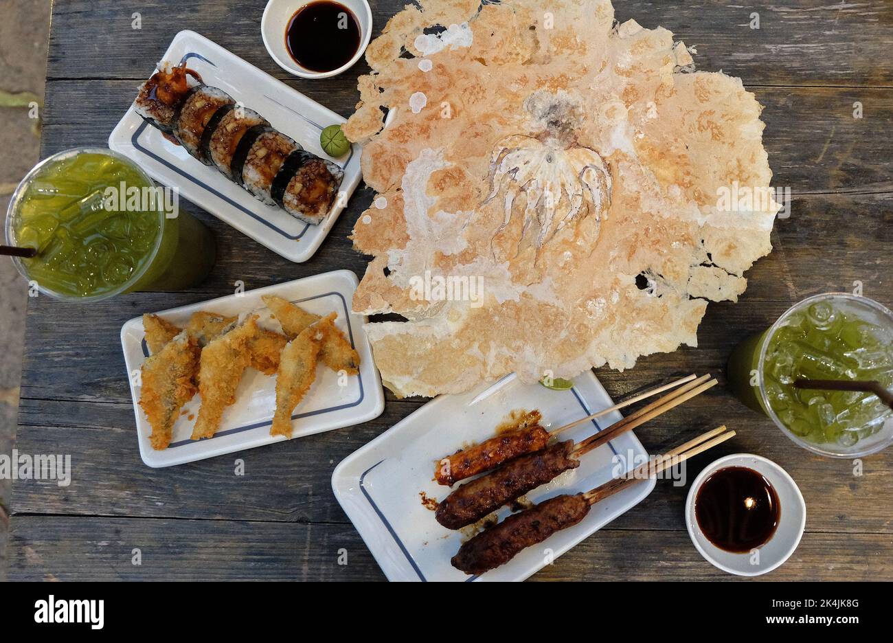 Izakaya(Japanese style street food) Chicken teriyaki skewers, deep fried Flying fish, Sushi Maki