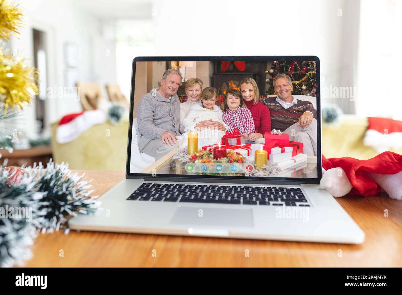 Smiling multi generation caucasian family on laptop video call screen at christmas. christmas, festivity and communication technology. Stock Photo