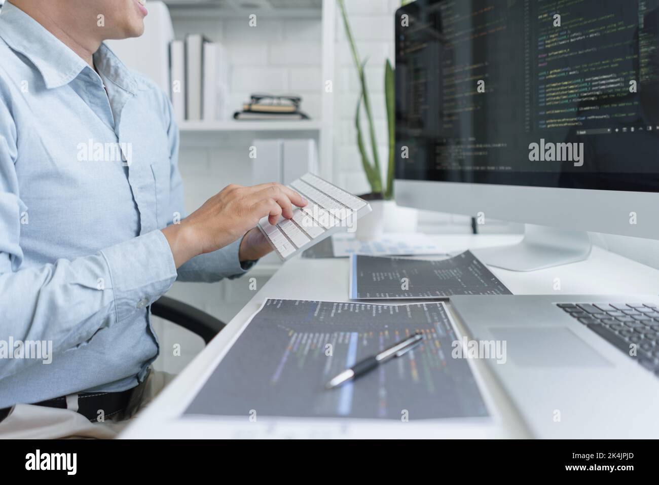 Software development concept, Male programmer using keyboard to typing data codes on computer. Stock Photo