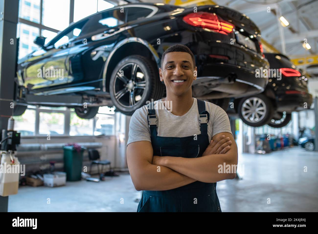 Happy automotive service technician in his workplace Stock Photo
