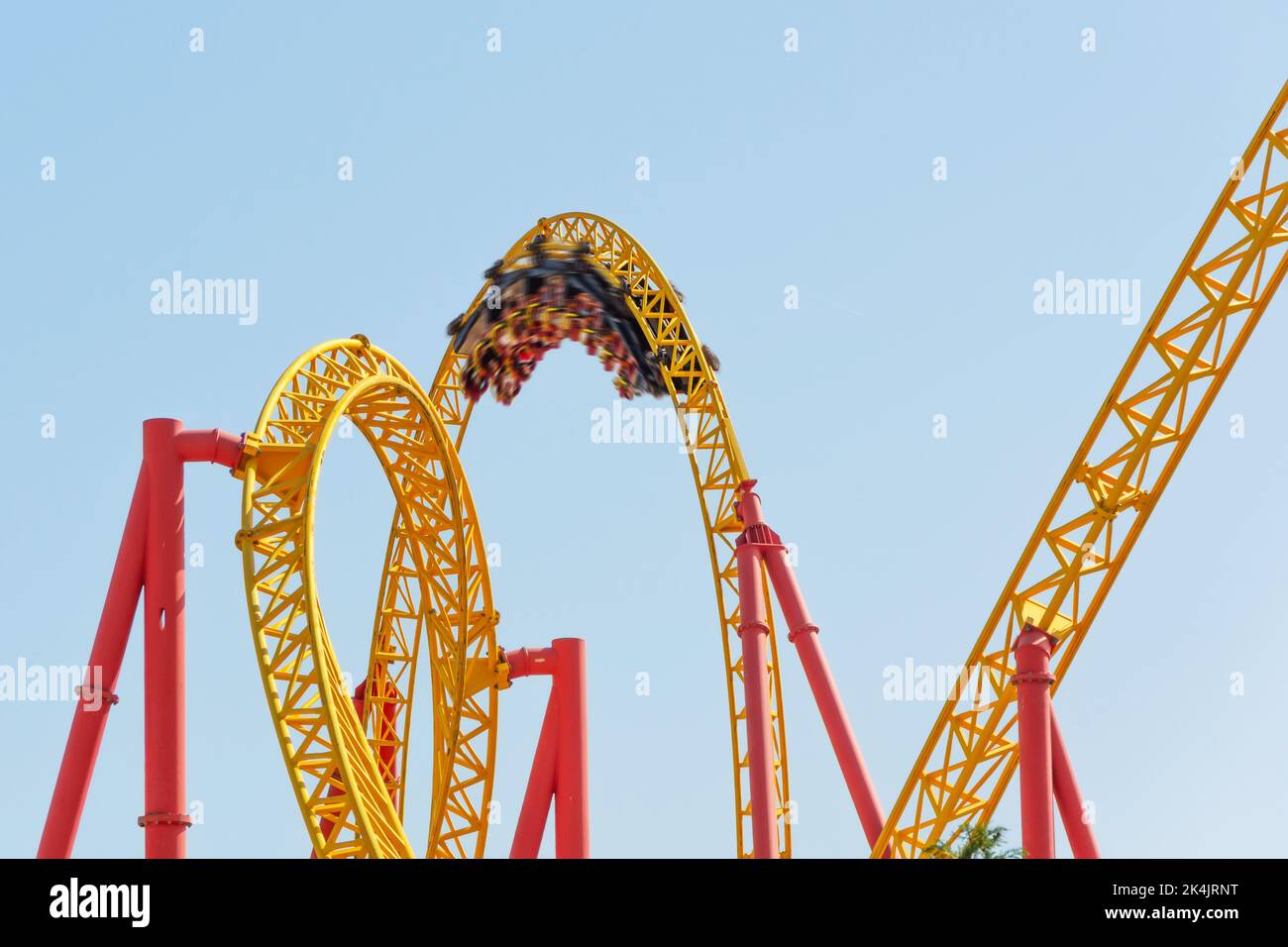 Amusement cart makes circular loops upside down at motion blur effect high speed, roller coaster Stock Photo