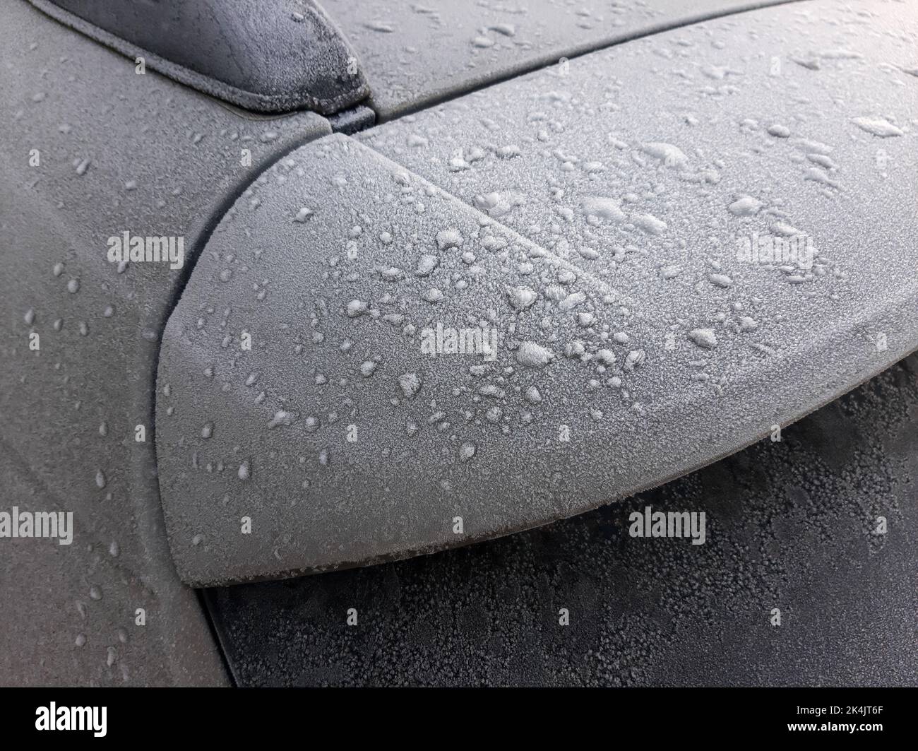 Snow covered car window with wipers, macro, close up Stock Photo
