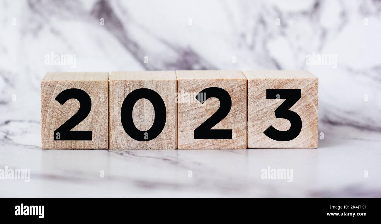 On a cube made of wooden blocks 2023 on a beautiful background. Preparing a new year and launching a new business goals strategy concept. Stock Photo