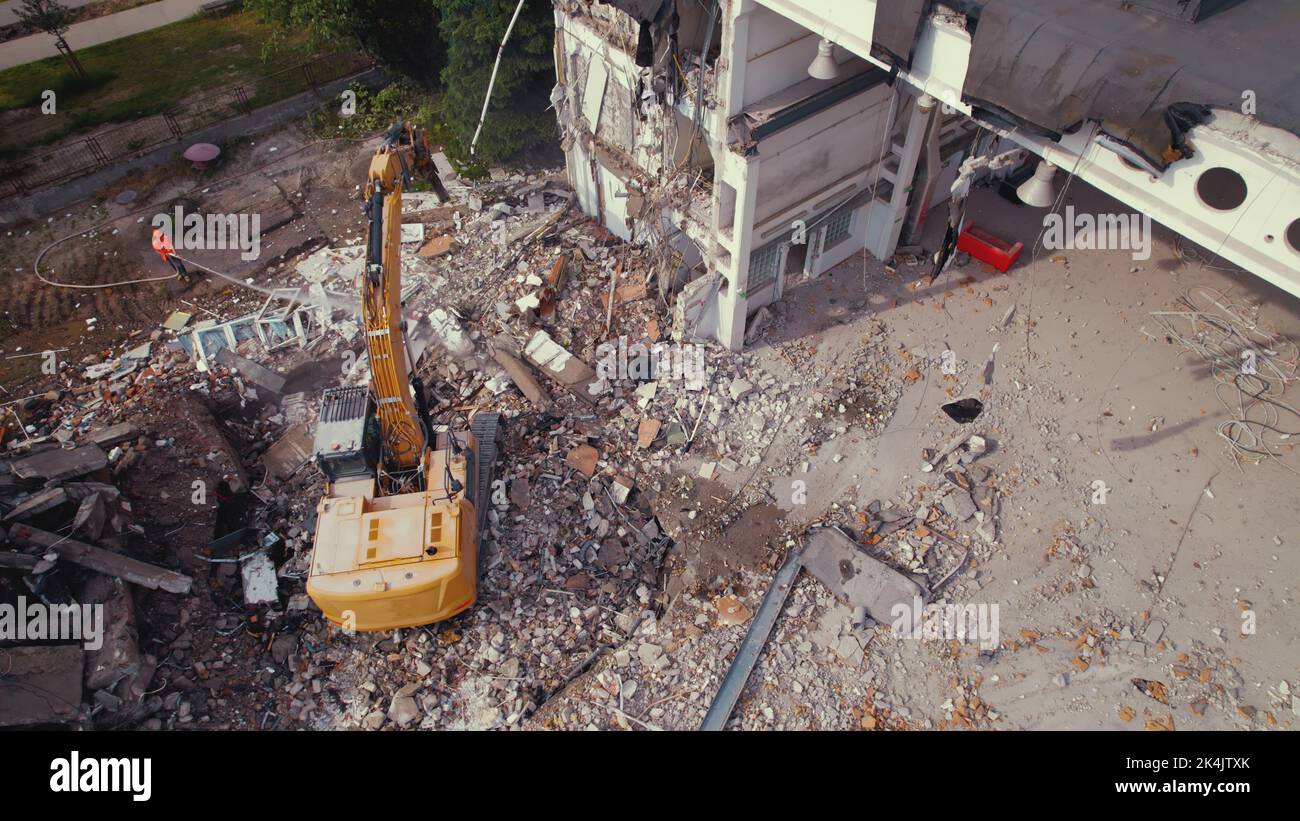 06.08.2022 - Warsaw, Poland - The excavator crusher taking down an old building, working on the demolition site. High quality photo Stock Photo
